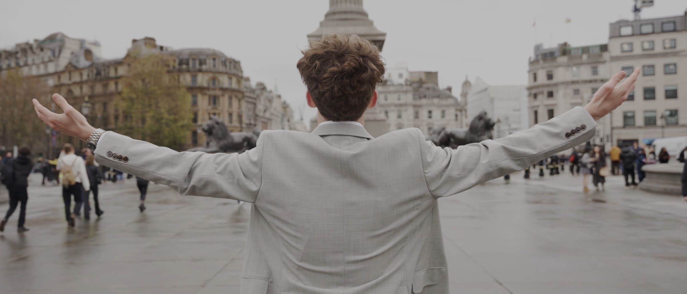 Blake Christopher Curtis with his arms out in Trafalgar Square, London