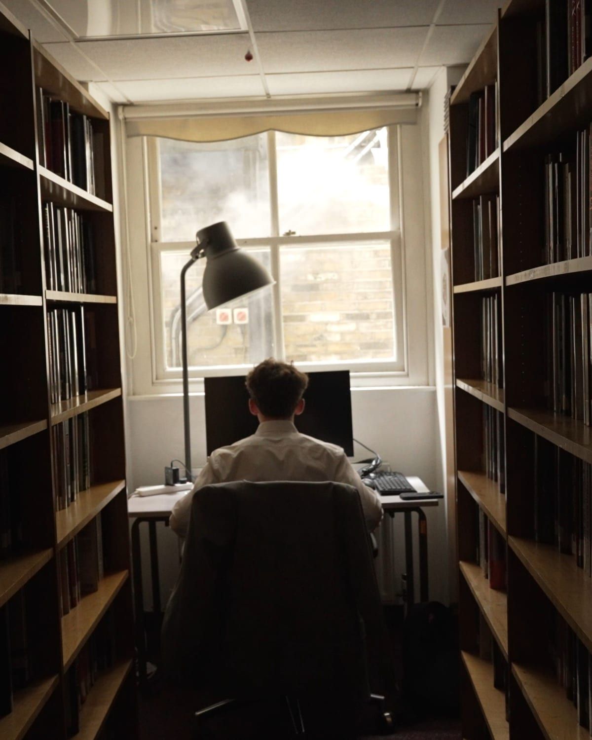 Blake Christopher Curtis at a desk by the window of a library, London