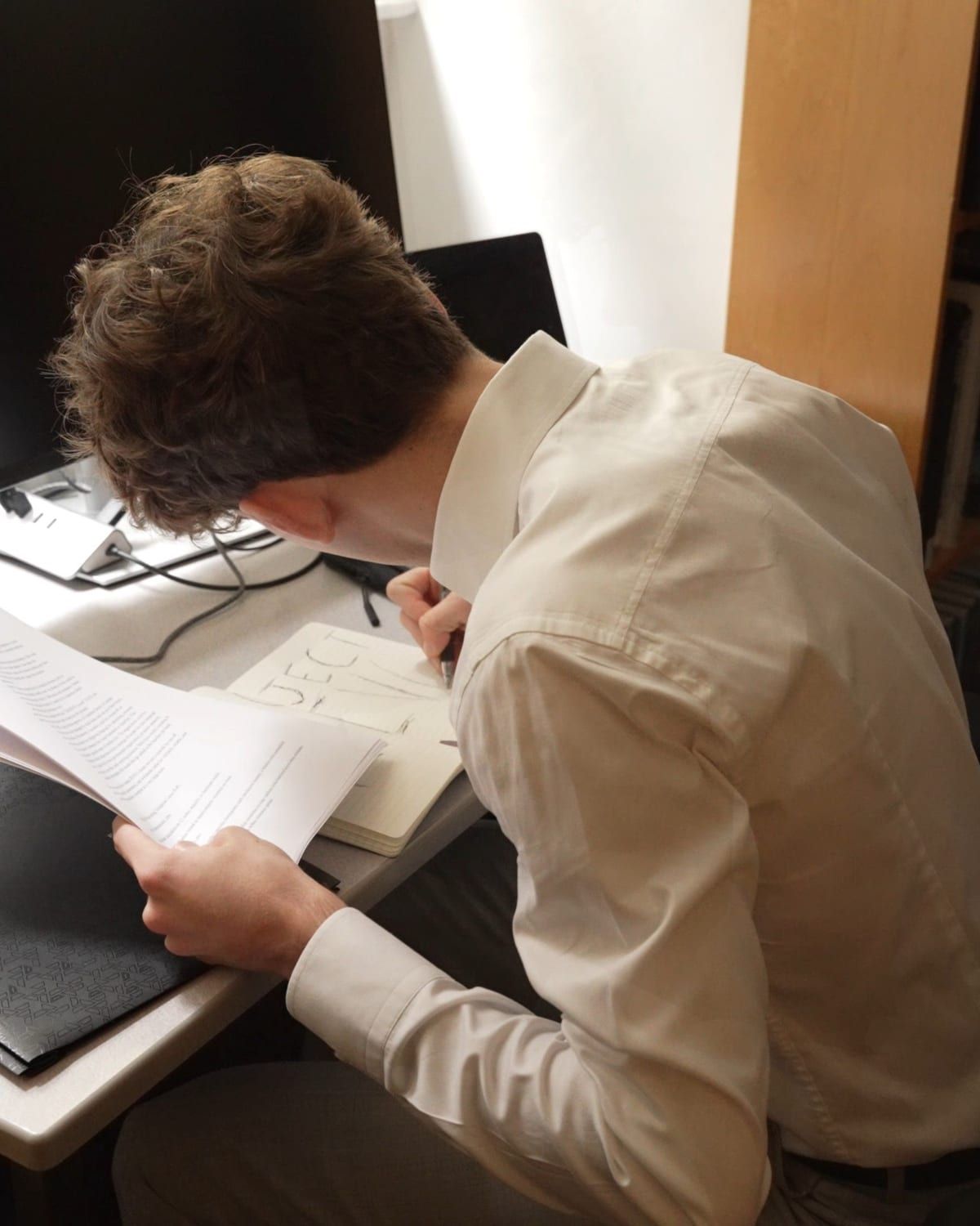 Blake Christopher Curtis writing at a desk
